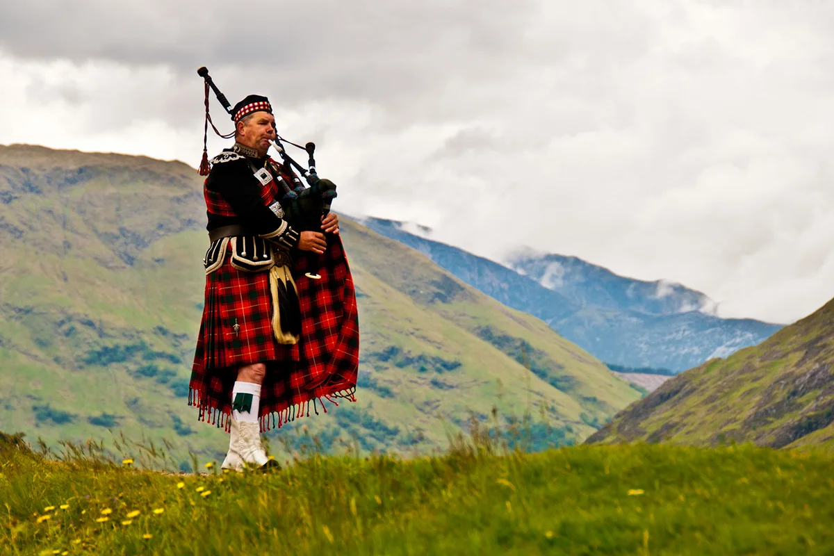 Highland bagpiper in kilt