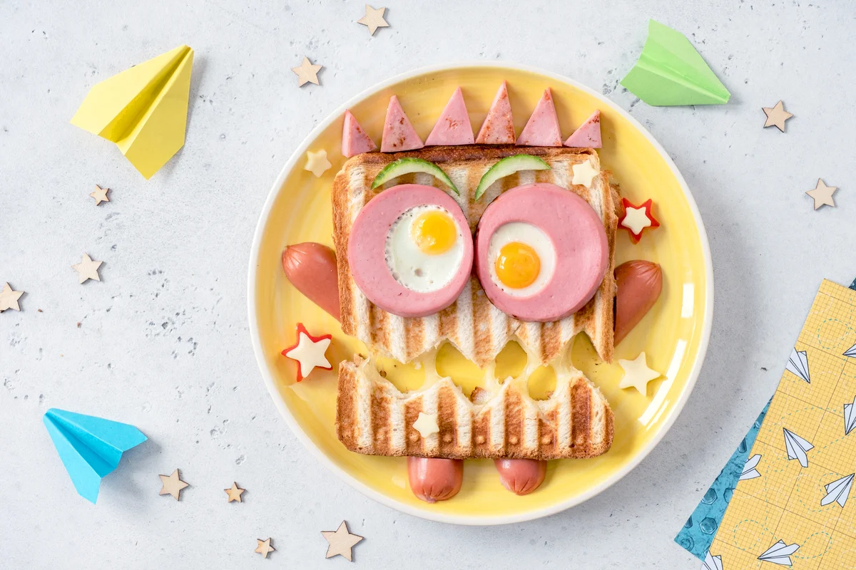 Monster sandwich with sausage, eggs and cheese on plate