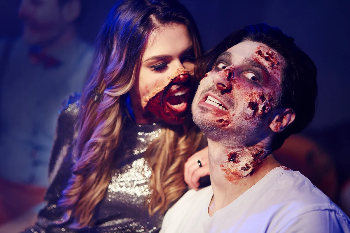 Creepy woman trying to bite her boyfriend at Halloween party