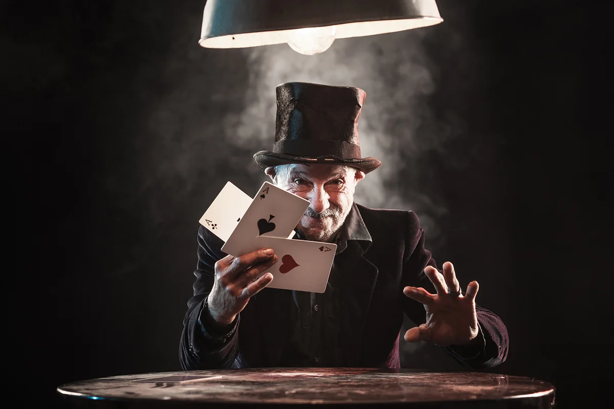 Senior man making trick with playing cards