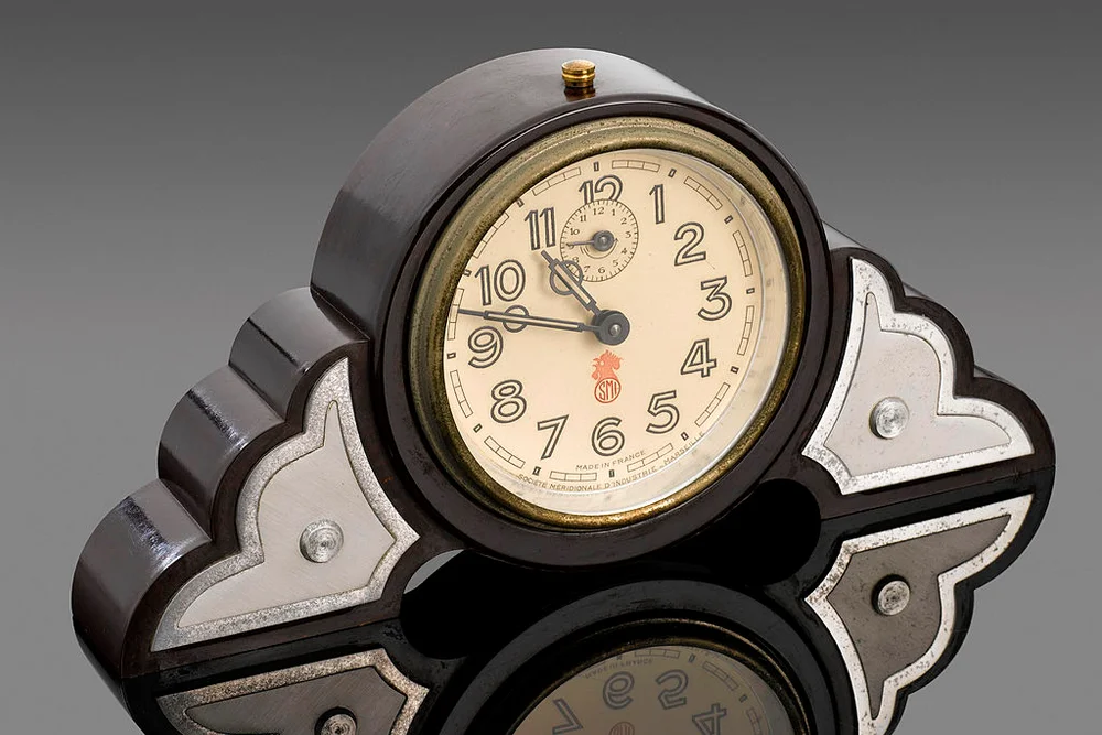 Dark brown, round-faced phenol formaldehyde (Bakelite) clock. France, 1930