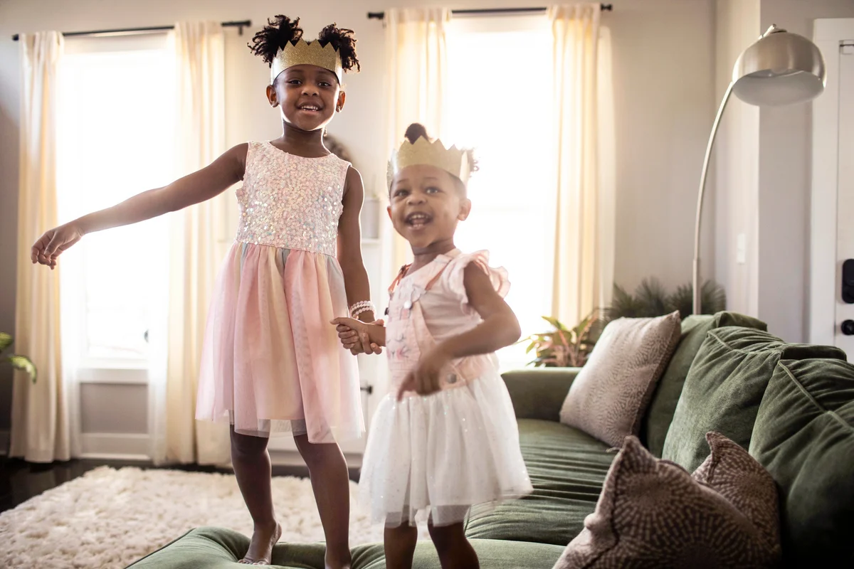 Young girls dancing and wearing homemade crowns