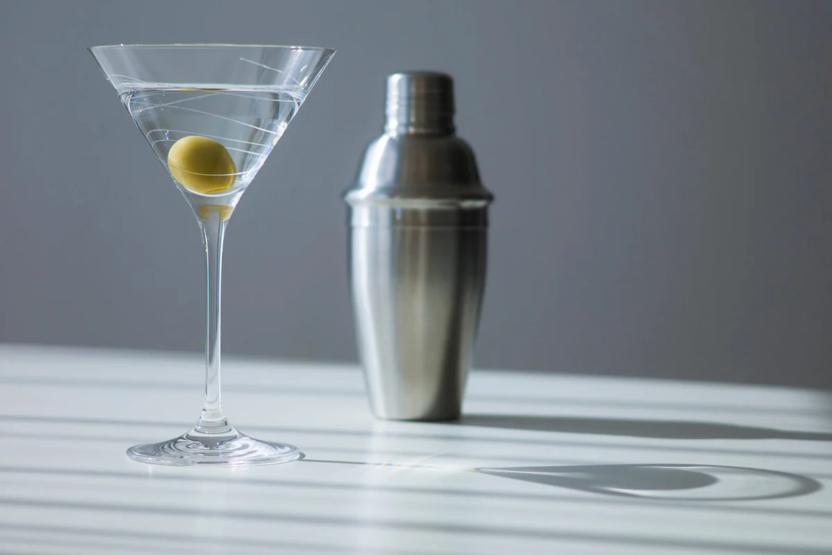 Cocktail shaker and cocktail in glass