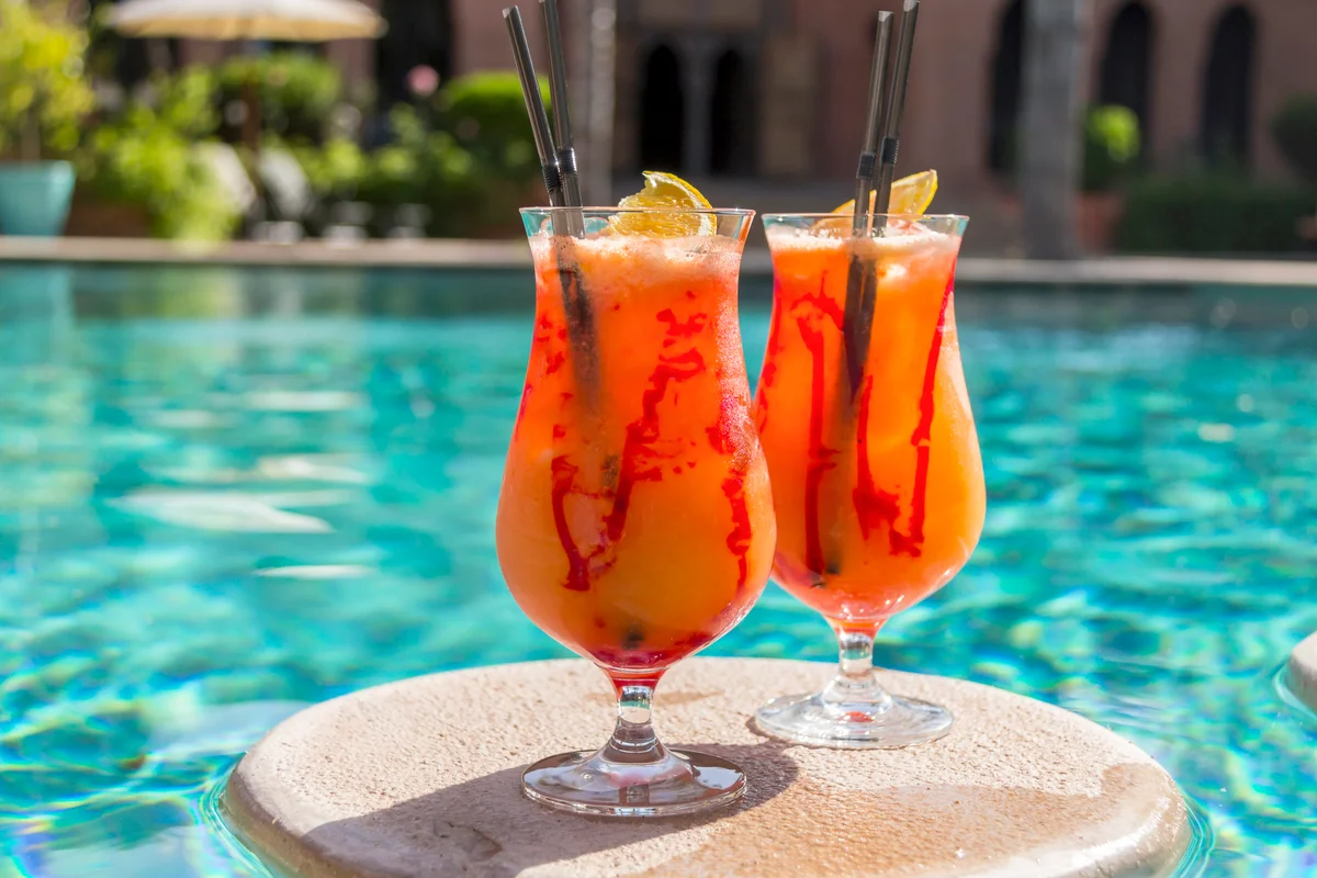 Fruity cocktails floating on swimming pool