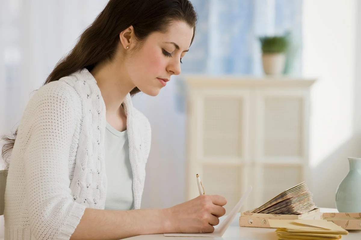 woman writing thank you letter after funeral