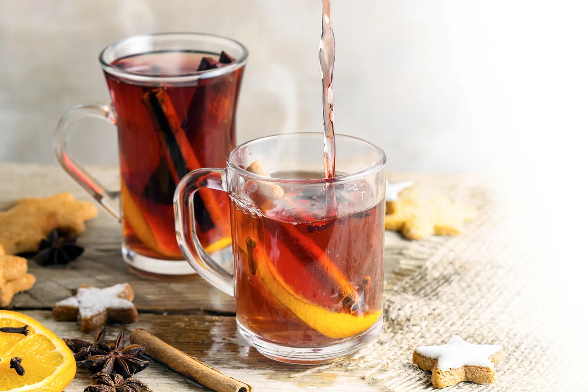 Black Tea Toddy Pouring In Cup On Table