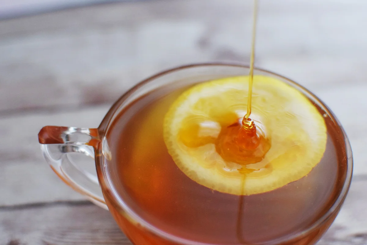 Honey Poured Over Lemon in Glass with Honey Toddy