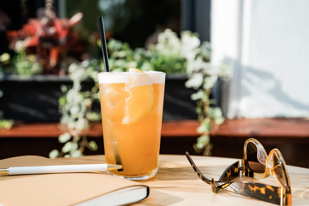 Bourbon cocktail in a frosted glass with a orange slice