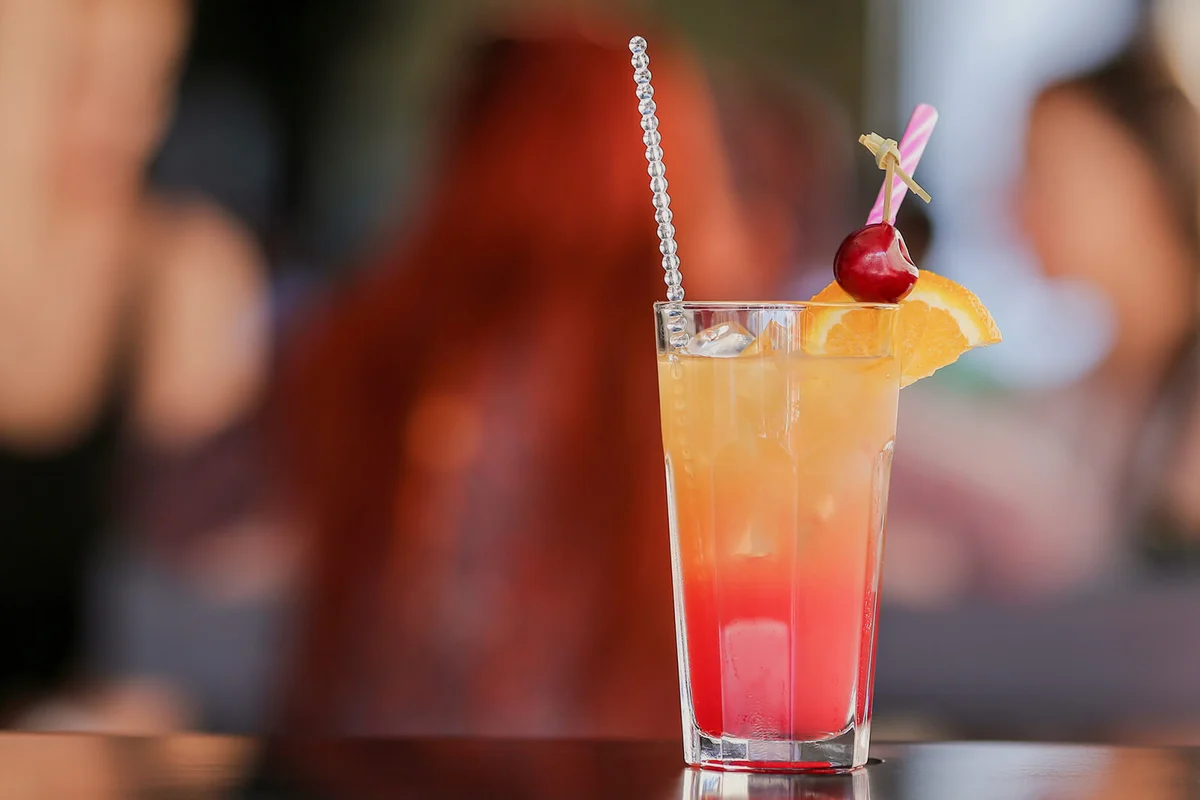 Cold tequila sunrise cocktail with tequila, pomegranate juice and orange juice