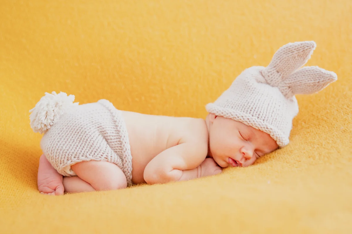 Baby dressed as a bunny photographed in a studio