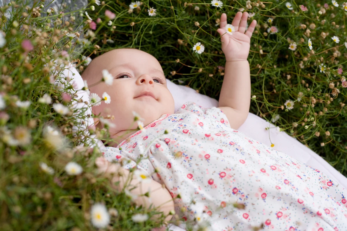 Baby lying among flowers