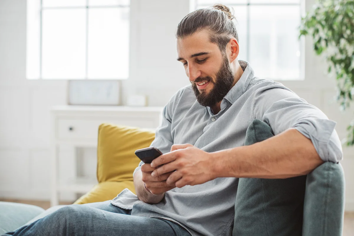 man texting compliment on social media