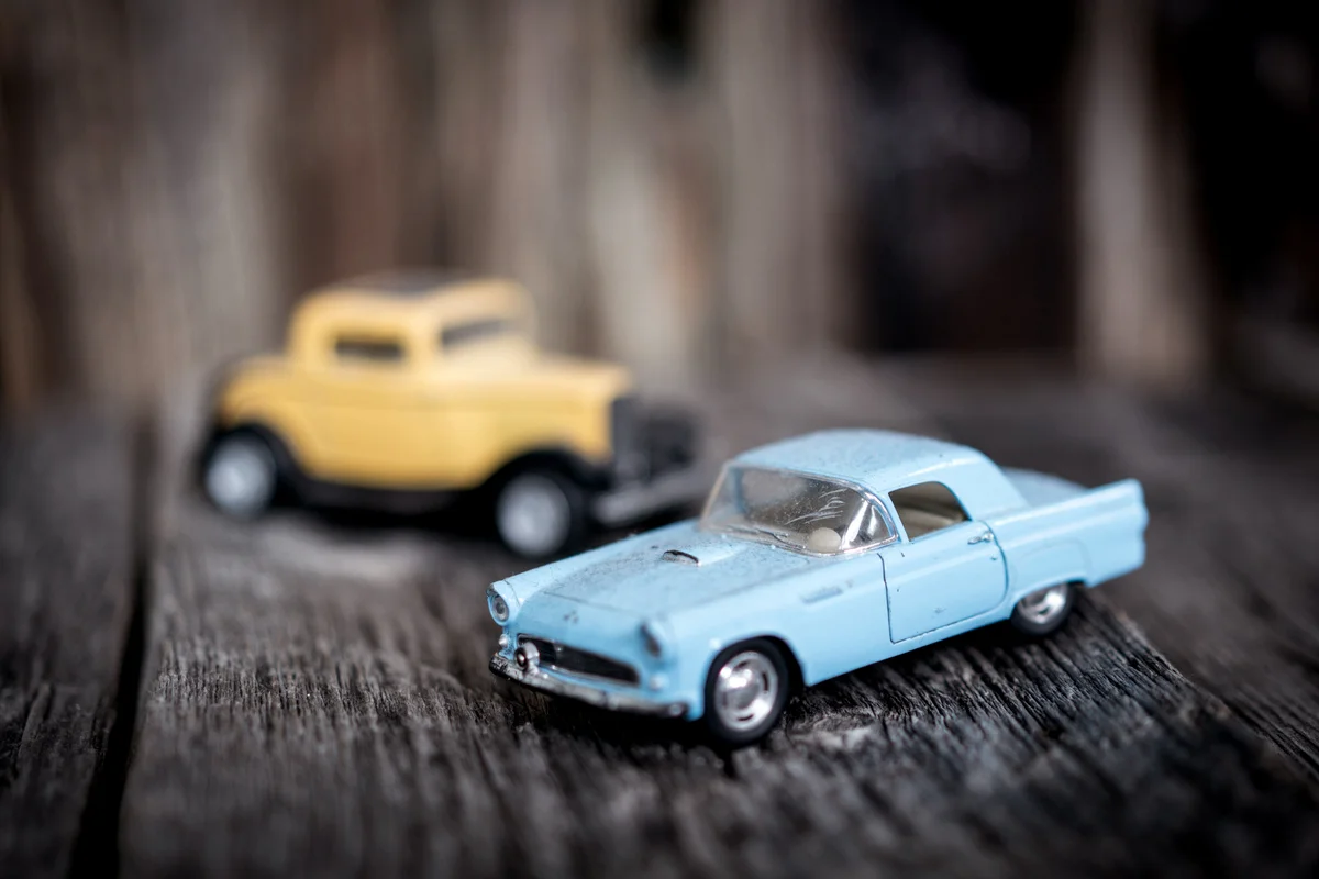 Toy vintage car on wooden background