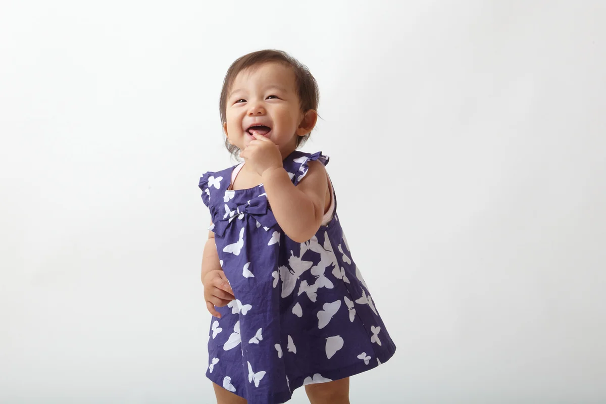Baby is standing with smile