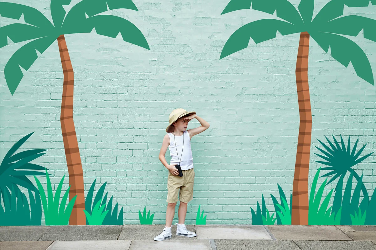 boy dressed as an adventurer with jungle scene