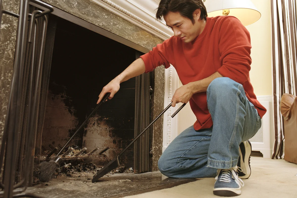 Man cleaning out fireplace
