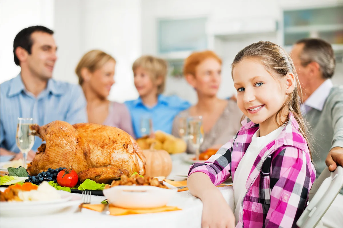 Family at dinner table for the Thanksgiving day