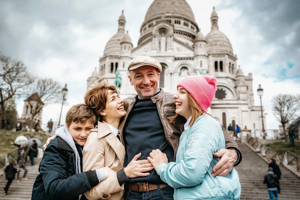 French family embraced in front of Sacre Coeur in Paris
