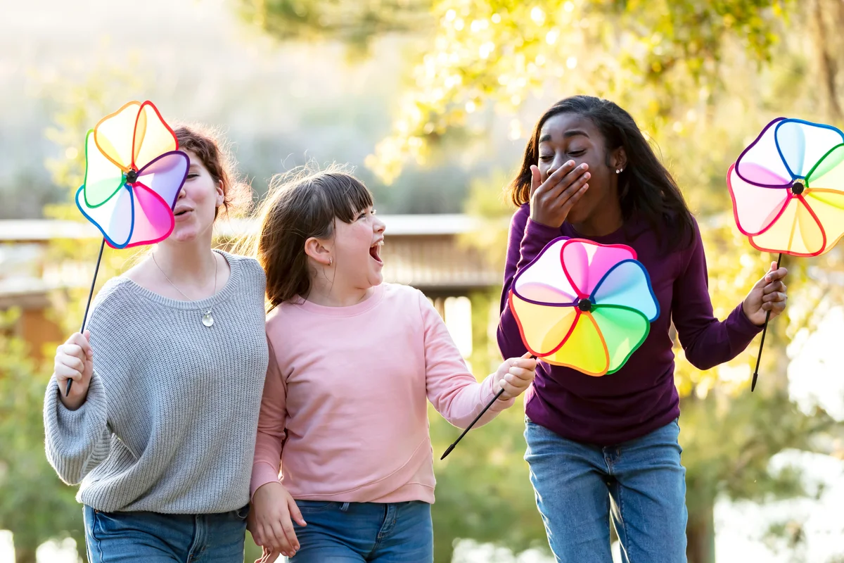 Sisters and step-sisters playing in a park