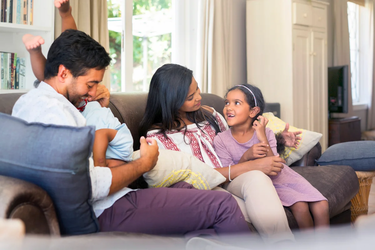 Parents having fun with children at home