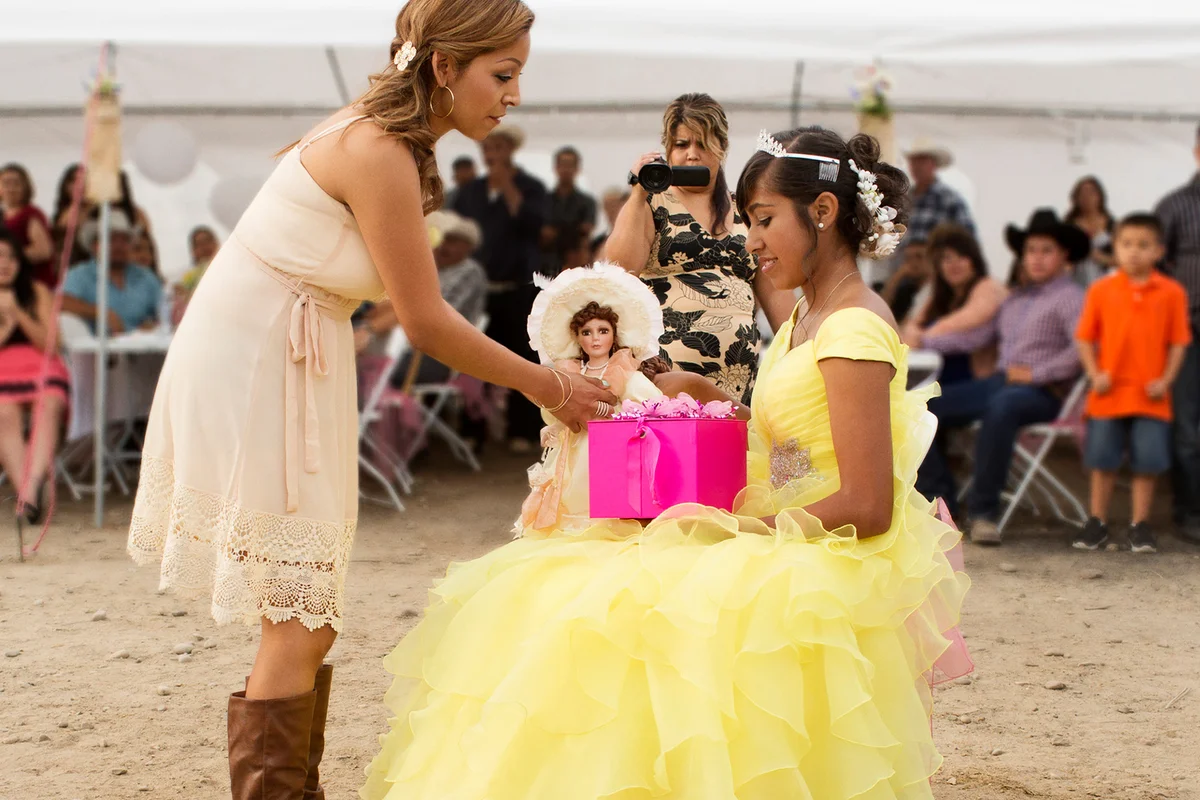Hispanic community giving gifts at quinceanera