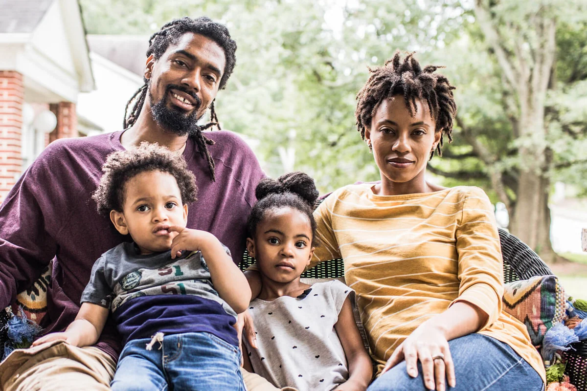 family in front of home
