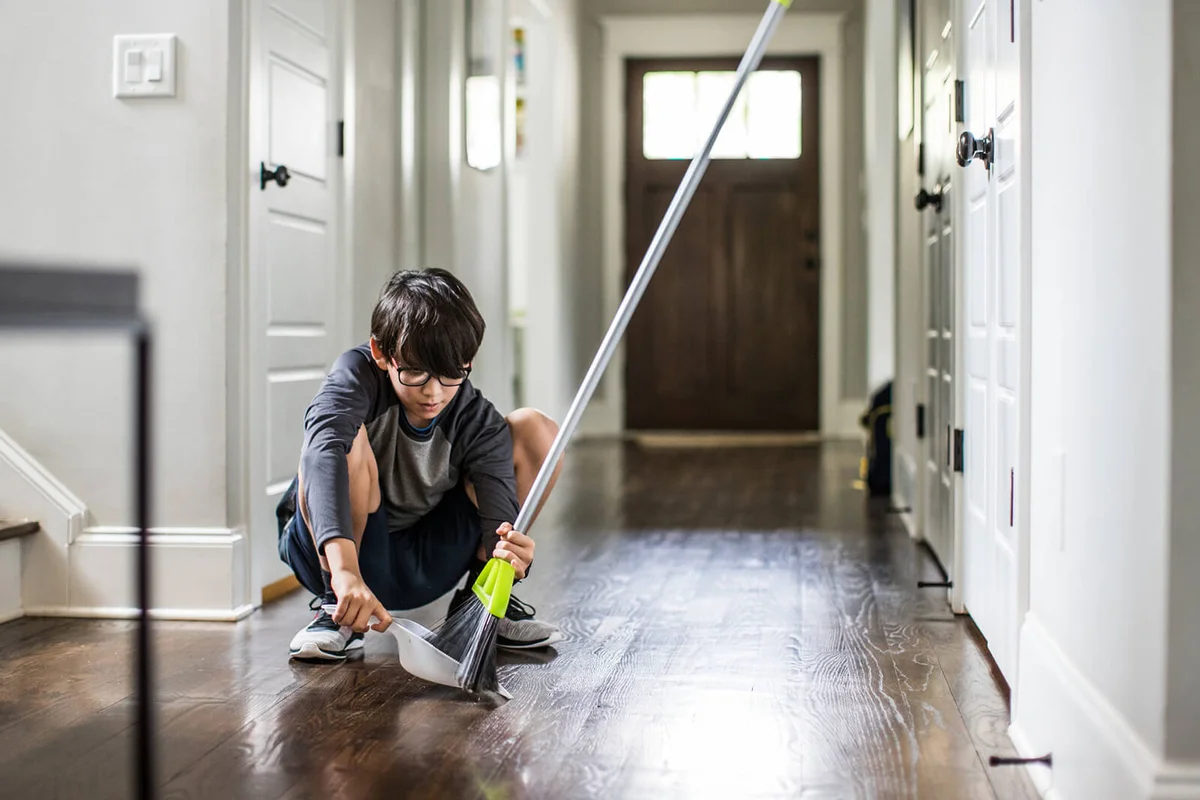 Young boy doing cleaning and doing chores