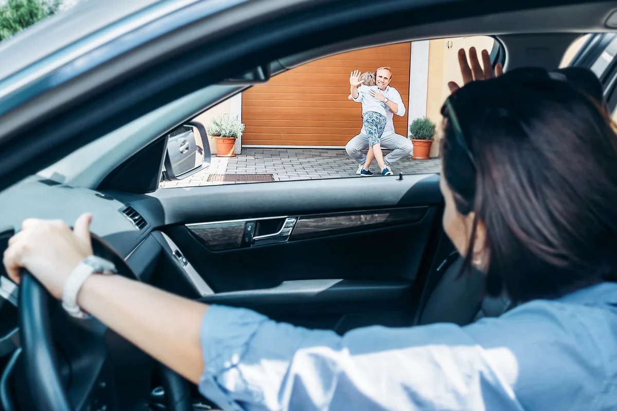 Woman dropping son to his father