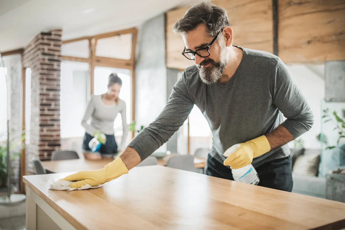 Father and daughter cleaning kitchen