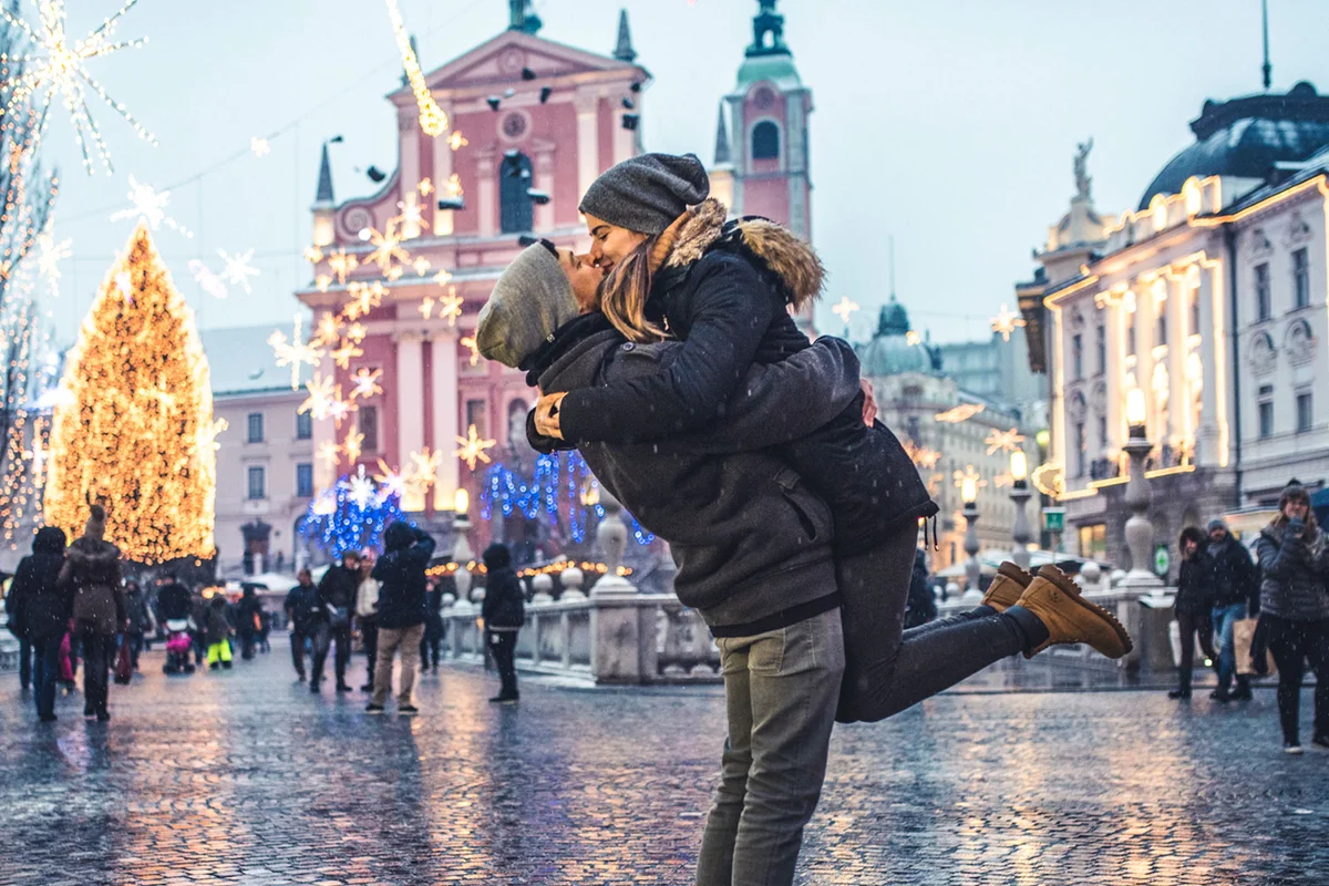 romantic couple embracing in city at Christmas