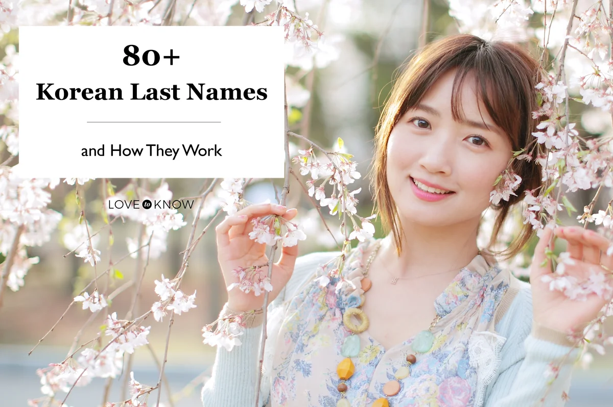 Young Korean woman between blooming cherry blossoms