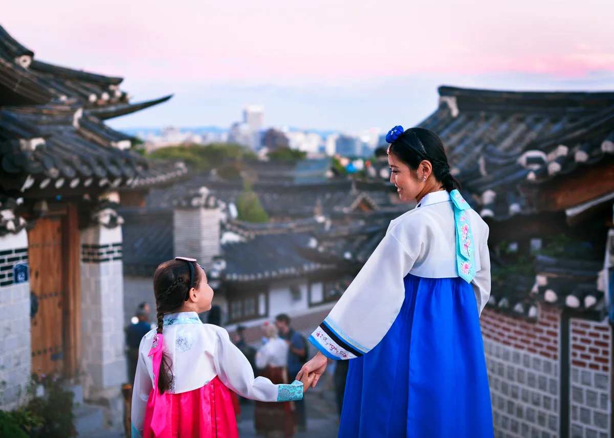 Korean Mother And Daughter Standing At Temple