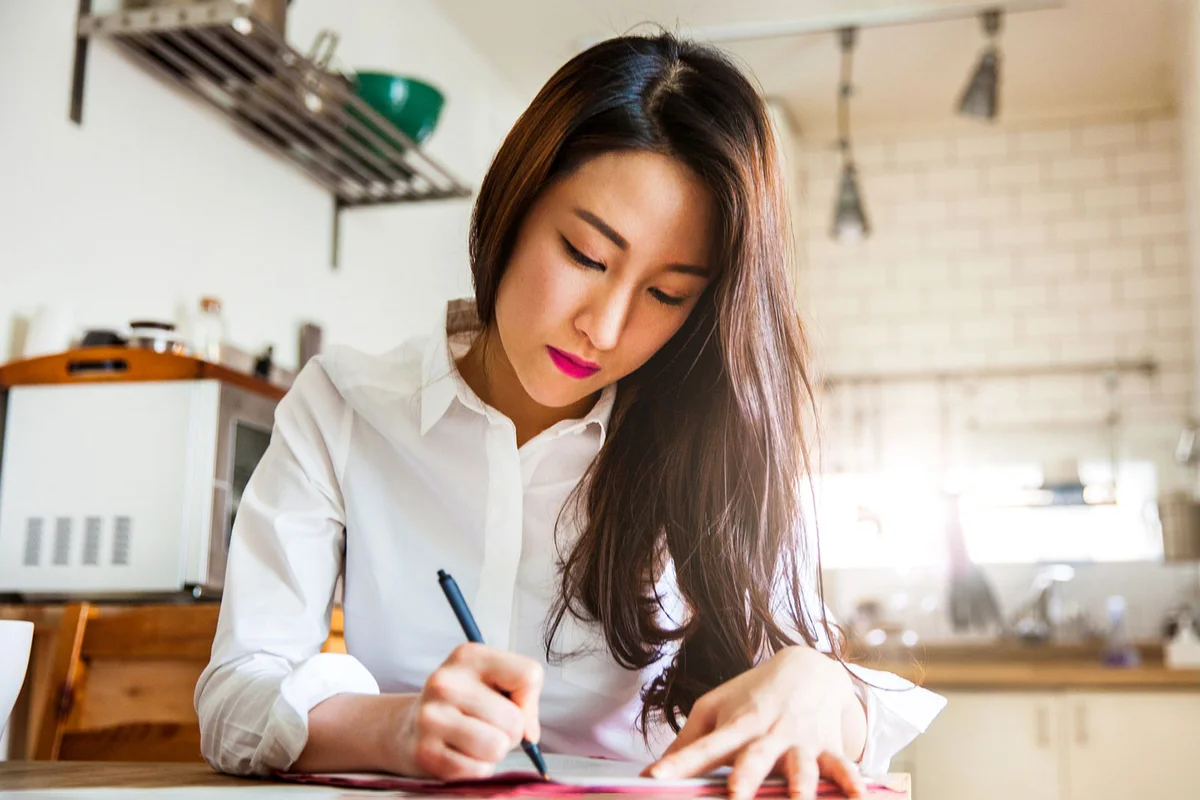 Korean woman writing Christmas cards