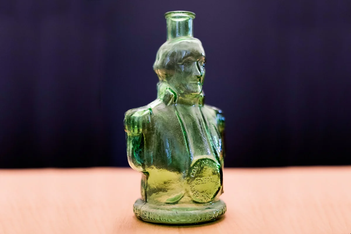 Green Glass Collectible Bottle by Wheaton NJ Shaped Like George Washington | Photo 184940207 © Barbaramacdonaldphotography | Dreamstime.com