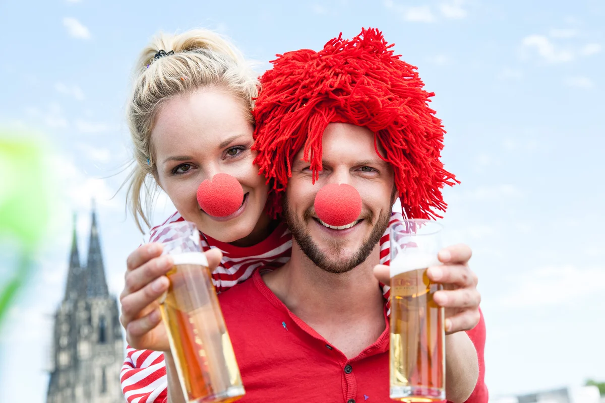 young couple celebrating dressed up as clowns