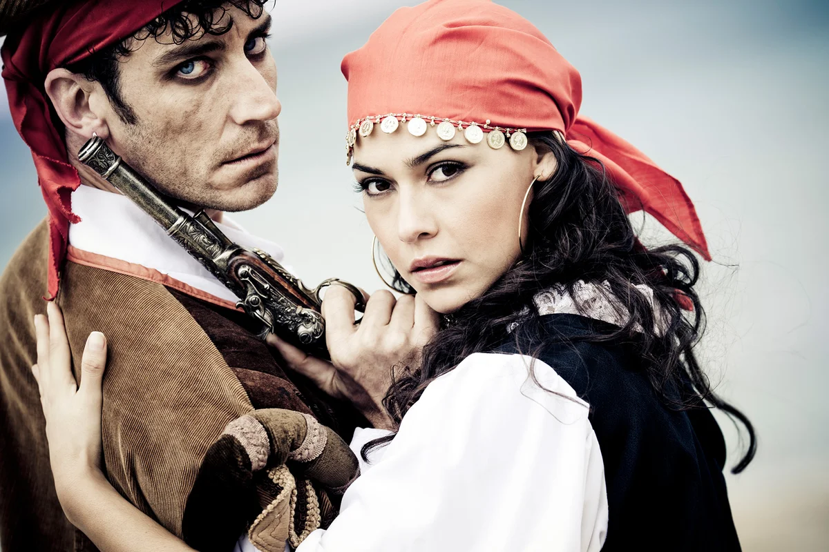 portrait of dramatic looking pirate couple