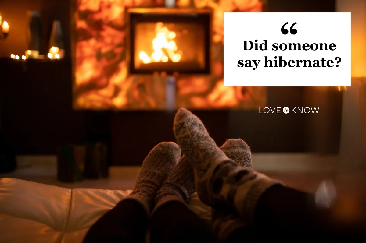 Feet in wool socks near fireplace in winter time