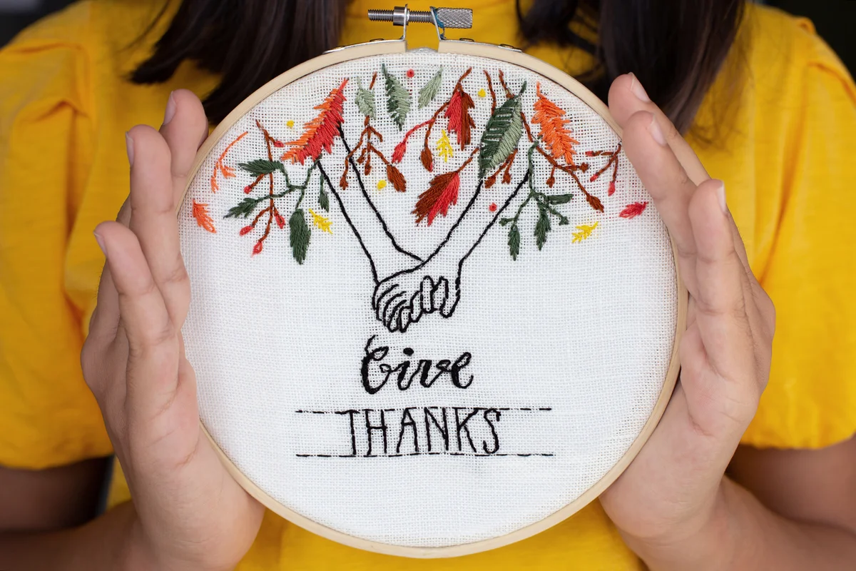 Girl showing her embroidery for Thanksgiving in a hop