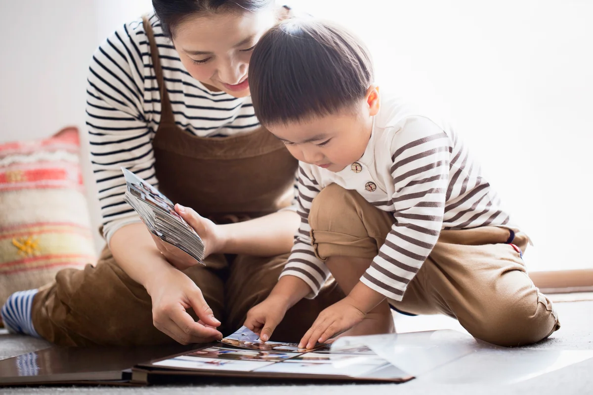 Mother and son making a photo album together