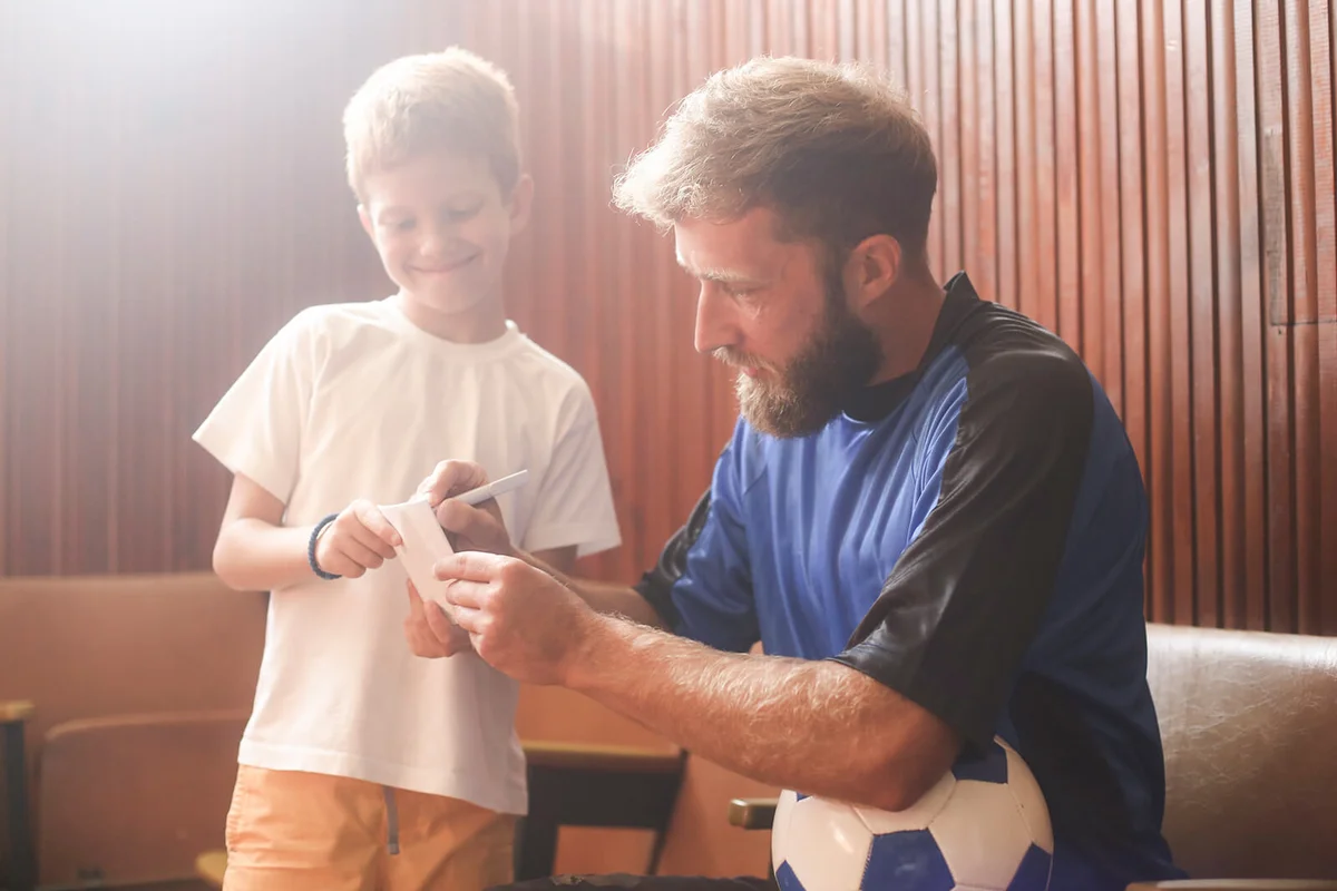 Soccer player giving an autograph