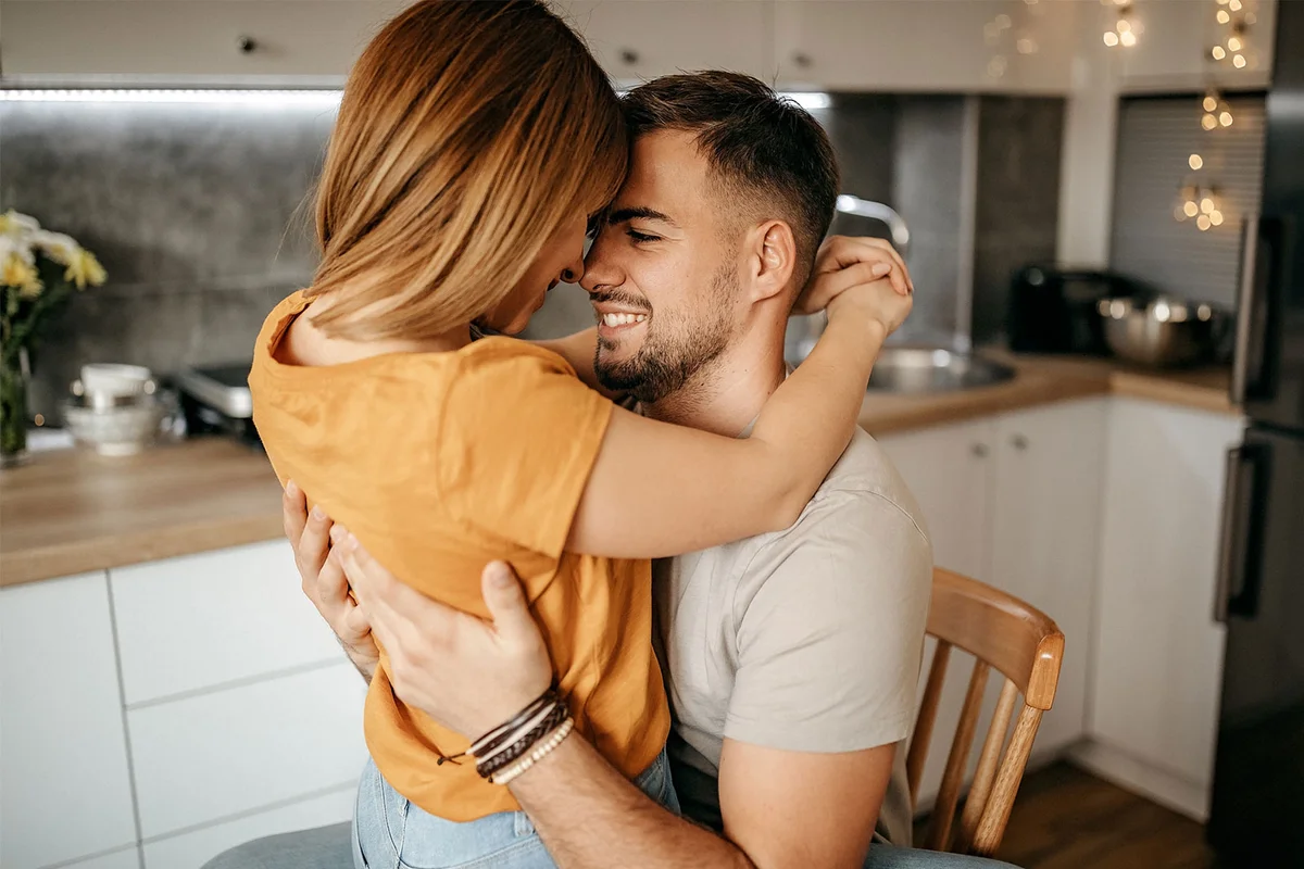 romantic couple woman sitting on man's lap