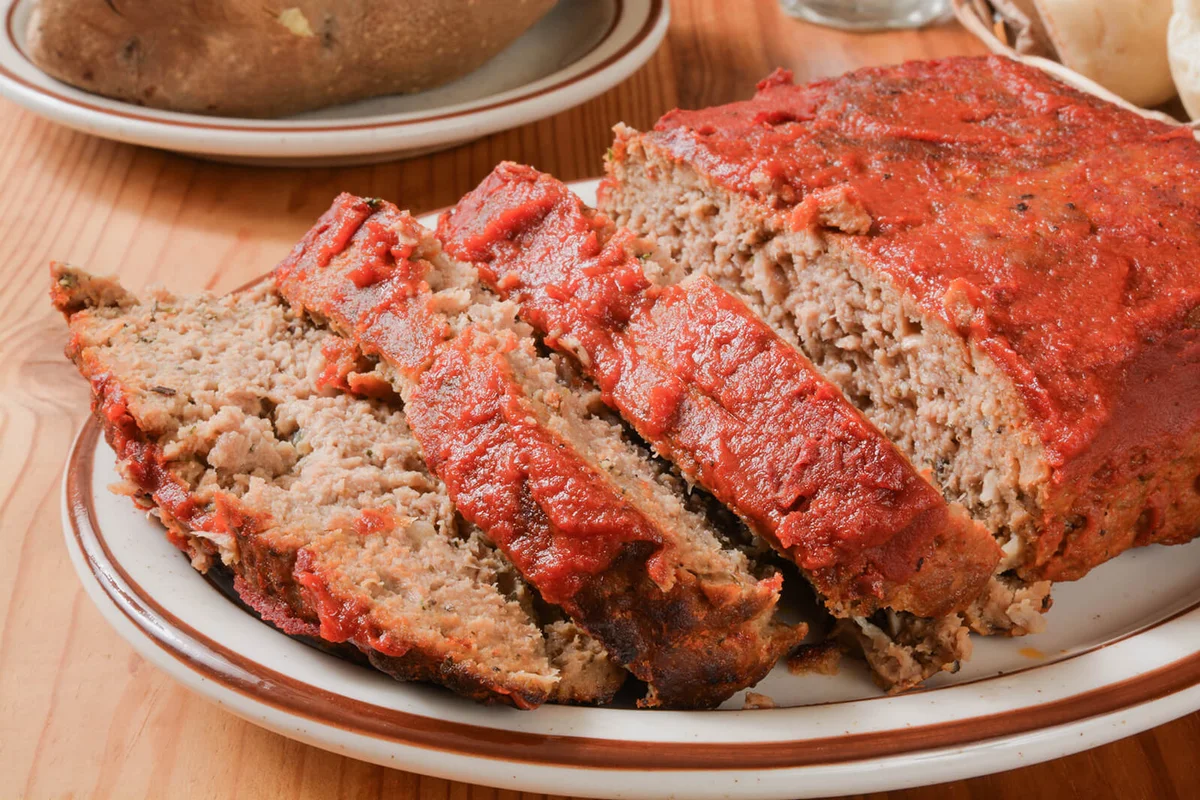 Meatloaf with tomato paste on a serving plate