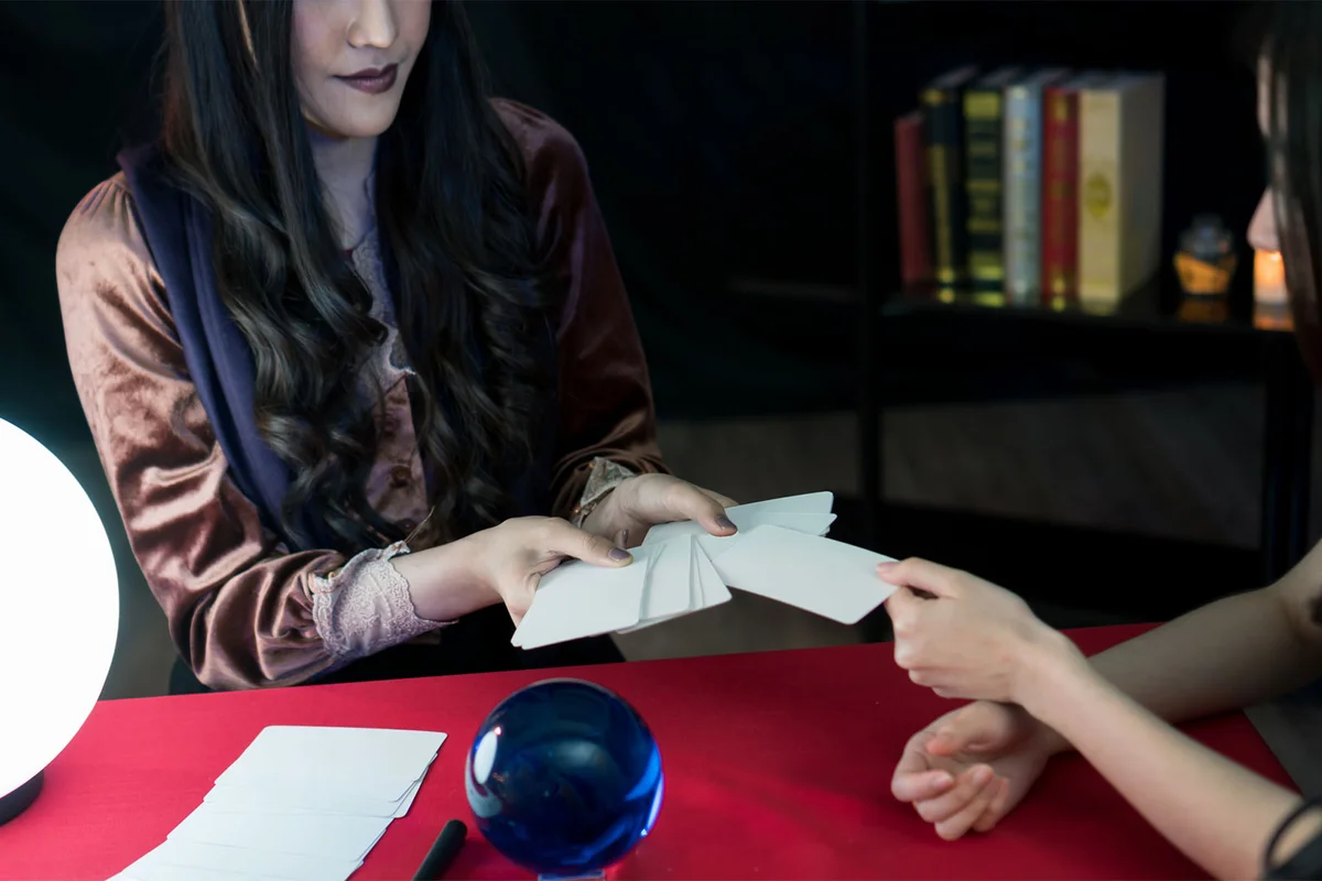 woman reading tarot card at adult halloween party