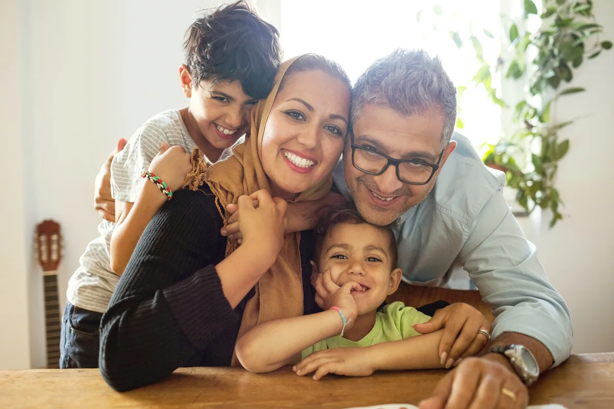 Portrait of happy family sitting at table
