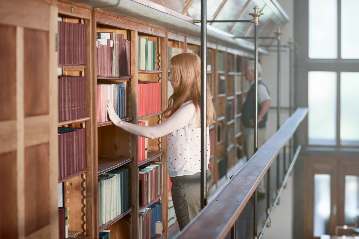 People searching for books in old library