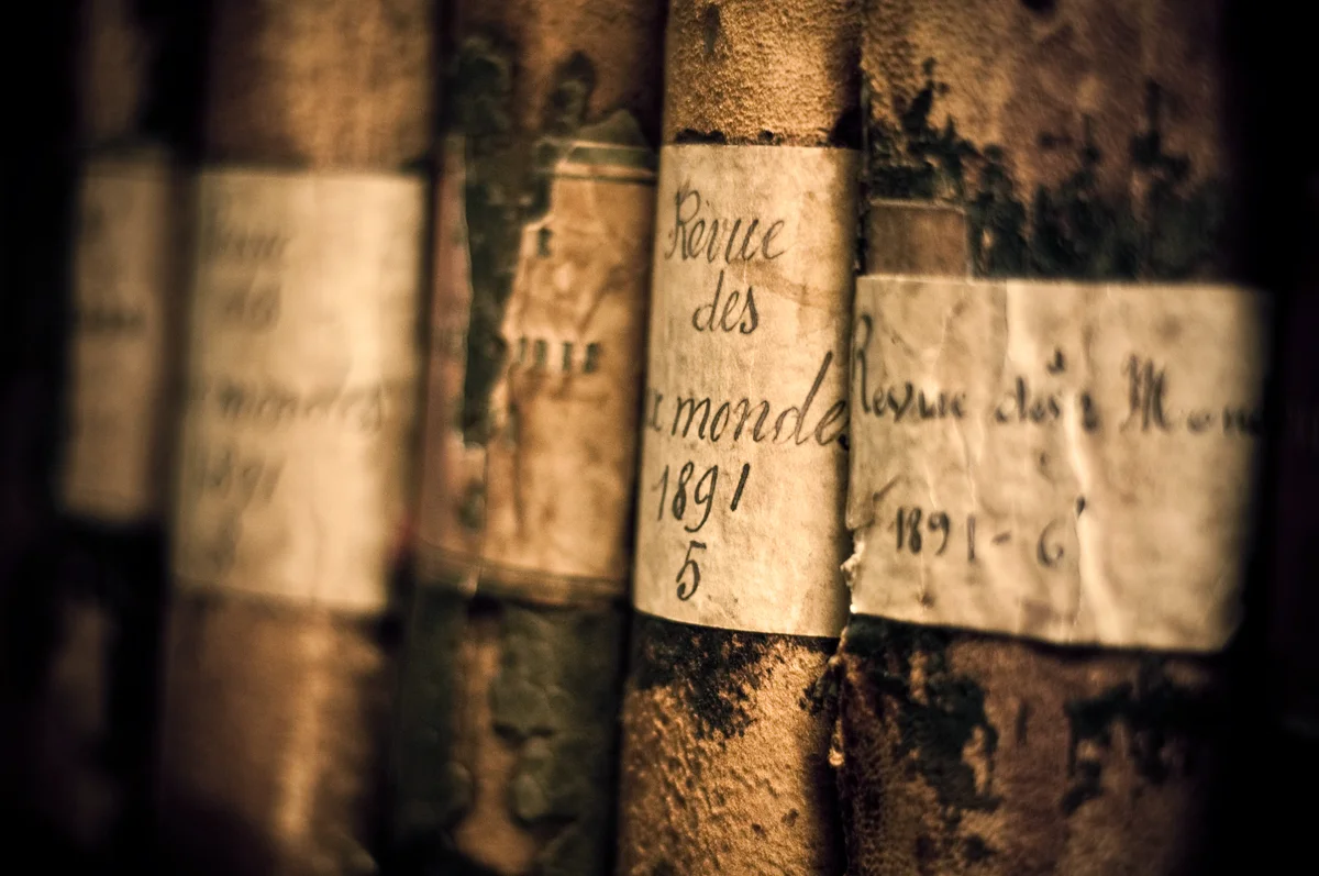 Old books from 1891 stacked in library
