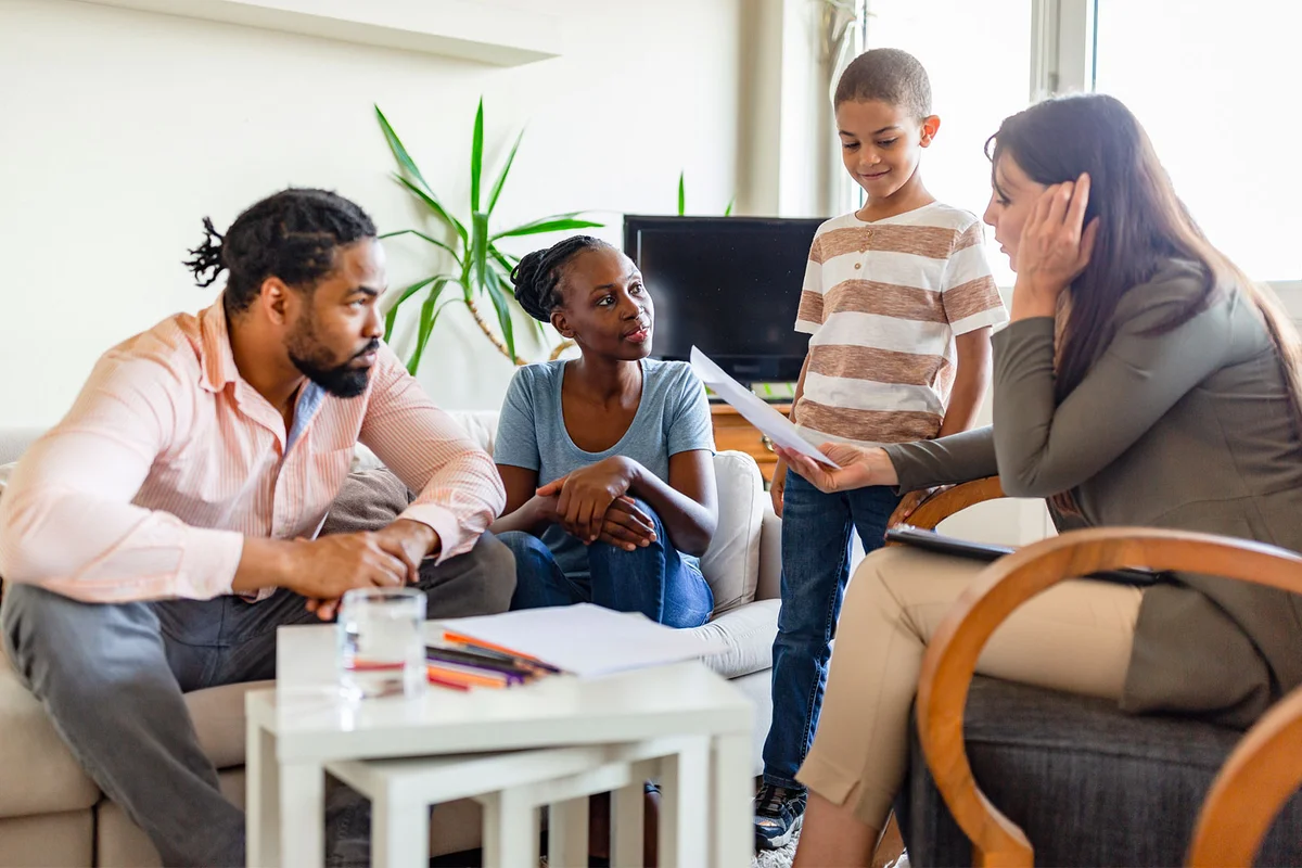 family having discussion with therapist