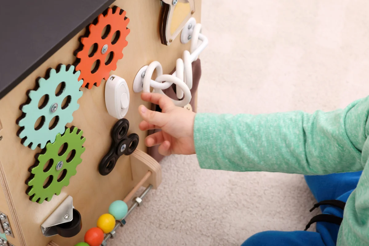Baby playing with diy sensory board