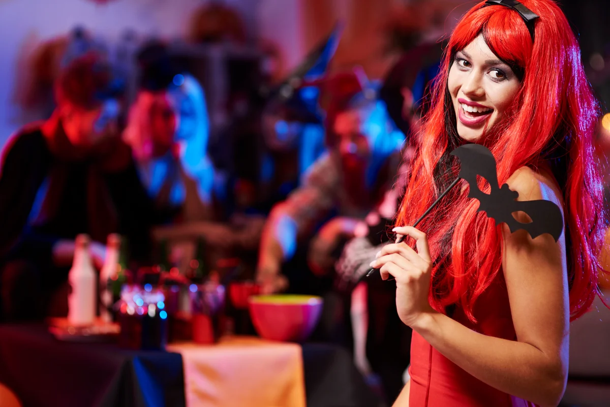 woman in devil costume at halloween party