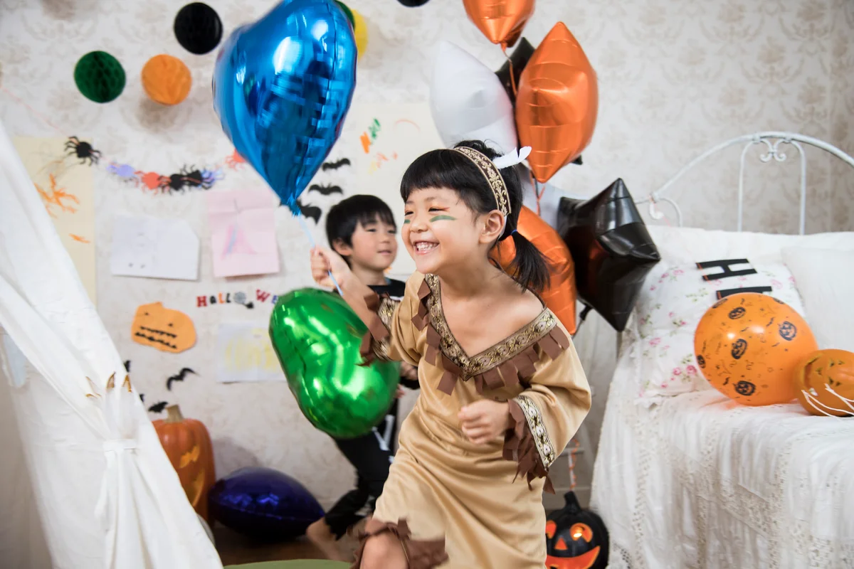 children wearing costumes playing in room